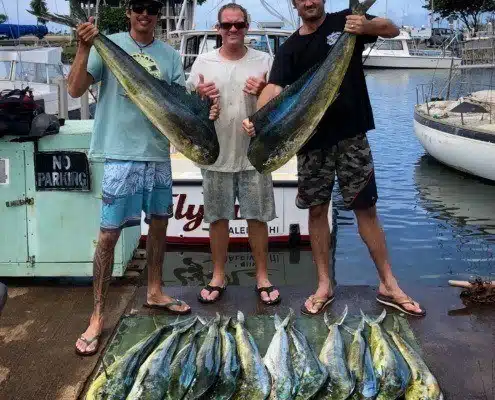 Mahi Mahi charter showing off their catch at the dock in Haleiwa, HI.