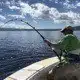 Fisherman catching north shore sport fish, Oahu. Flyer offers the best Hawaii fishing charters.