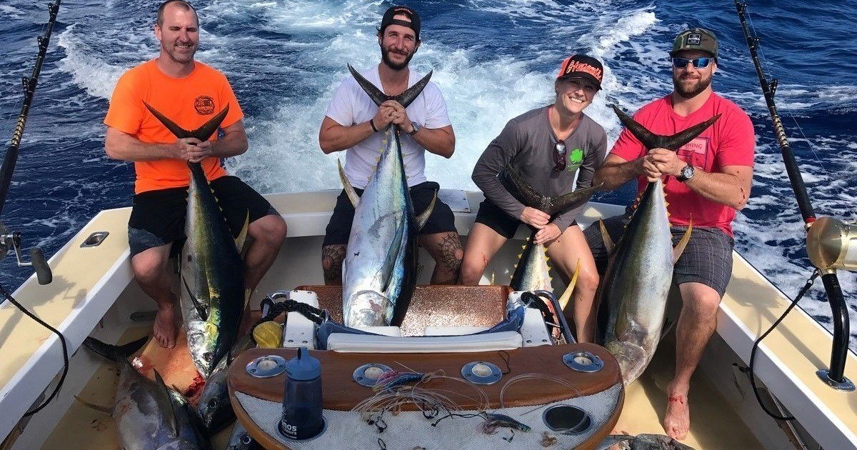 North Shore Ahi charter group taking a photo with their catch. Oahu deep-sea fishing charter, north shore.
