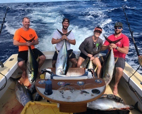 North Shore Ahi charter group taking a photo with their catch.