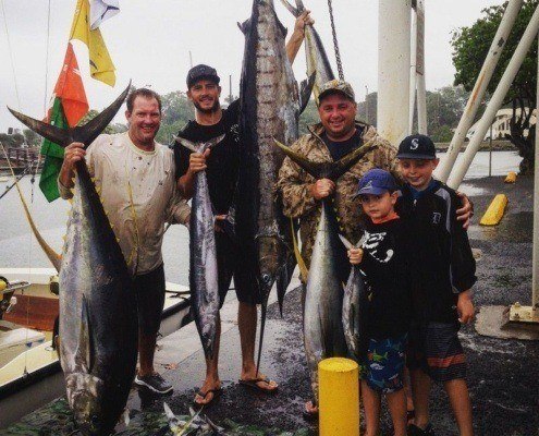Stripe Marlin sport fishermen showing off their catch on the docks on the North Shore.