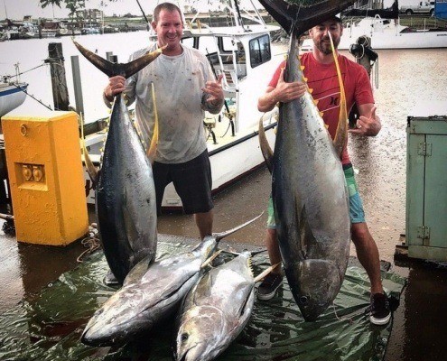 Private-yellowfin-tuna- charter on Oahu displaying their catch at the docks.