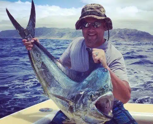 mahi-mahi-catch-2 Fisherman showing off a mahi-mahi caught during a private Oahu fishing tour.