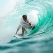 fishoahu-blog-surfing Man surfing in wave on North Shore. Flyer Sportfishing offers North Shore fishing charters on Oahu North Shore