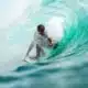 Man surfing in wave on North Shore. Flyer Sportfishing offers North Shore fishing charters on Oahu North Shore