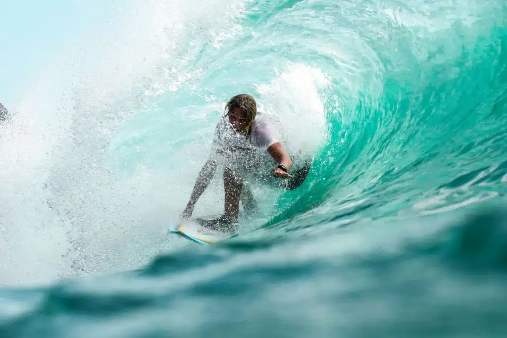 fishoahu-blog-surfing Man surfing in wave on North Shore. Flyer Sportfishing offers North Shore fishing charters on Oahu North Shore